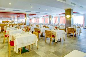 Restaurant im SBH Taro Beach Hotel mit vielen gedeckten Tischen und Stühlen.