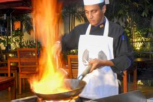 Koch vom Occidental Eden Beruwala brät mit einem brennenden Wok in der Hotelküche