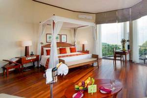 Luxuriöse Suite im Occidental Eden Beruwala mit Blick auf das Meer, einem großen Bett und einer Terrasse.
