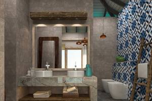 Modernes Badezimmer mit grauen Fliesen und blauen Mustern, zwei Waschbecken und Toiletten