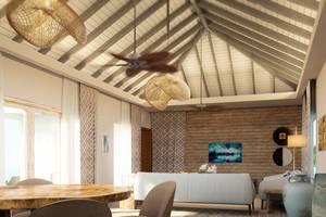 Innenansicht des Esszimmers im Hotel You & Me Maldives mit Holzboden und weißen Möbeln.