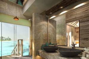 Badezimmer mit Meerblick im You & Me Maldives Hotel, mit zwei Waschbecken und einer großen Glastür.