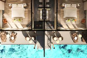 Luftaufnahme des You & Me Maldives Hotels mit Wasserbetten und Aussicht auf das Meer.