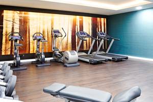 Fitnessraum im Novotel London Blackfriars mit drei Laufbändern und anderen Trainingsgeräten.