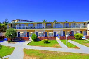 Außenansicht des Blue Bay Beach Resorts mit Swimmingpool und Sonnenliegen.