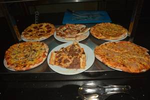 Verschiedene Pizzasorten auf Tellern in einem Hotelrestaurant