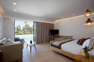 Hotelzimmer von Lyttos Mare mit einem Bett, einer Couch und einem Fernseher.