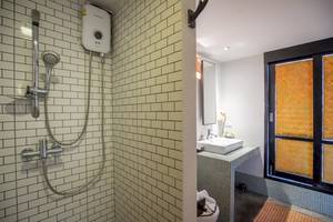 Ein Badezimmer mit einer Dusche, einem Waschbecken und einer Toilette im Punnpreeda Beach Resort.