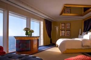 Schlafzimmer im Burj Al Arab Jumeirah mit Blick auf das Meer, einem großen Bett, Dekor und Blumen.