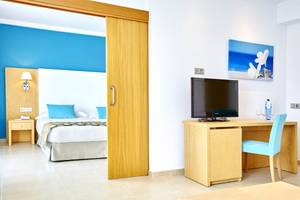 Hotelzimmer im Marques Hotel mit Bett, Schreibtisch und Fernseher.