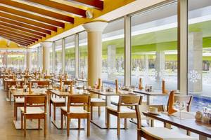 Innenansicht des Restaurants des Barcelo Maya Beach Hotels mit vielen Tischen und Stühlen.