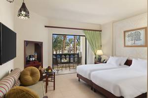 Doppelzimmer im PickAlbatros Oasis Port Ghalib Hotel mit Blick auf Palmen und Terrasse.