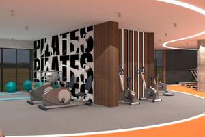 Innenansicht des Fitnessstudios im Lago Hotel mit Trainingsgeräten und Pilates-Wand