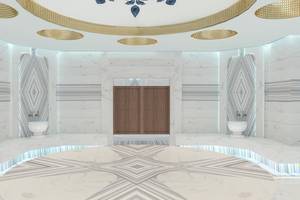 Innenraum Design des Lago Hotels mit Marmorboden, weißen Wänden und goldenen Deckenelementen.