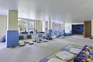Kinderzimmer im Santiburi Koh Samui Hotel mit blauen Möbeln und Teppichen.