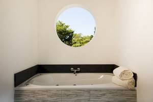 Badewanne mit Ausblick auf Bäume im Emotions By Hodelpa Hotel
