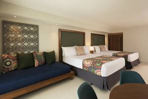 Schlafzimmer im Emotions By Hodelpa Hotel in Puerto Plata mit zwei Betten und einem Sofa.