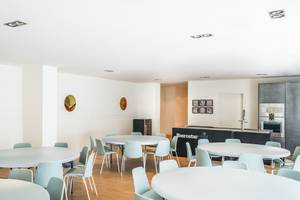 Eine Speiseraum mit runden Tischen und Sitzen im Iberostar Cristina Hotel.
