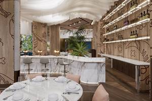 Innenraum des Gloria Serenity Resorts mit Esstisch, Bar und modernen Möbeln.