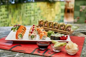 Sushi-Platte auf einem Tisch im Gloria Golf Resort mit Sojasauce und Beilagen.