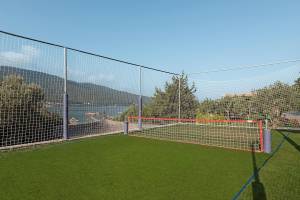 Fussballfeld mit Netz im Freien neben einem Hotel am Meer