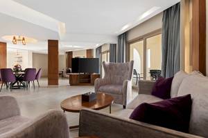 Wohnbereich im Xanadu Makadi Bay Hotel mit Sofa, Sessel, Tisch, Fernseher und Esstisch