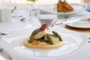 Fischgericht auf einem weißen Teller im H10 Blue Mar Boutique Hotel Restaurant