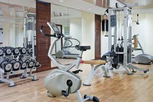 Fitnessraum des H10 Blue Mar Boutique Hotels mit Geräten und Spiegeln.