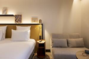 Hotelzimmer im Mercure Paris Bercy Bibliothèque mit Bett, Sofa und Nachttisch