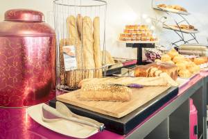 Frühstücksbuffet des Mercure Paris Centre Tour Eiffel mit Brot, Gebäck und Marmeladen.