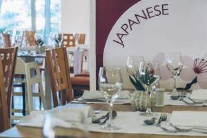 Ein Tisch in einem japanischen Restaurant, gedeckt mit Gläsern und Besteck.