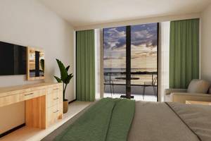 Suite-Zimmer im Sunrise Queen Luxury Hotel mit Blick auf das Meer und einem Balkon.