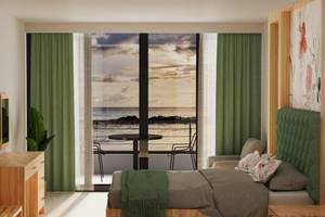Suite-Zimmer mit Meerblick und Balkon im Sunrise Queen Luxury Hotel.