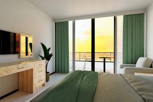 Modernes Schlafzimmer mit Balkon und Meerblick im Sunrise Queen Luxury Hotel.