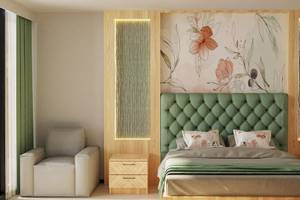 Modernes Schlafzimmer mit grünem Kopfteil und Blumentapete.