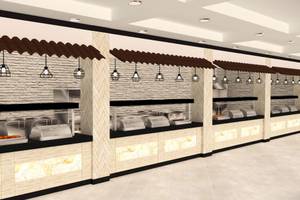 Innenansicht des Buffetbereichs im Sunrise Queen Luxury Hotel mit mehreren Edelstahl-Buffetstationen, braunen Dächern und Beleuchtung.