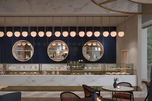 Innenansicht des Cafes des Sunrise Queen Luxury Hotel mit Marmortheke und beleuchteten Kuchen