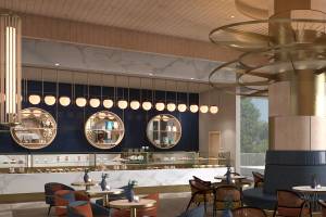 Der Innenbereich des Sunrise Queen Luxury Hotel mit Tisch, Sofa und einer Theke voller Kuchen.