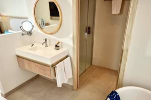Badezimmer des Victoria Menorca Hotels mit Waschbecken, Spiegel und Badewanne
