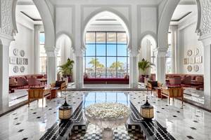 Lobby des Steigenberger Resort Alaya mit weißen Wänden, Marmorboden und großen Glasfenstern.