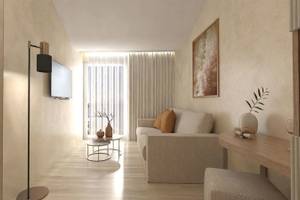 Wohnzimmer im Alexandra Beach Resort mit moderner Einrichtung und offenem Fenster.