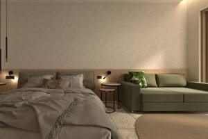 Modernes Schlafzimmerdesign im Alexandra Beach Resort mit Bett, Couch, Nachttischen und Teppich.