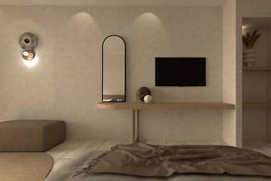 Ein modernes Zimmer im Alexandra Beach Resort mit einer weißen Wand, einem großen Spiegel, einem Fernseher und einem kleinen Tisch.