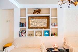 Wohnzimmer mit Sofa und Regalwand im Sunrise Hotel Samos