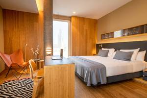 Hotelzimmer im Ocean Drive Barcelona mit einem Bett, Schreibtisch, Stühle und Blick auf die Stadt.