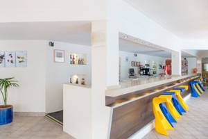 Rezeption im La Santa Maria Playa Hotel mit modernem Design und bunten Stühlen.