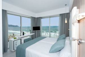 Hotelzimmer mit Meerblick am Kyrat Amarac, mit Bett, Schreibtisch und Fernseher.