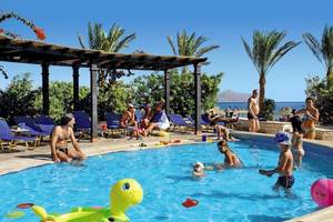 Gäste am Poolbereich des Jaz Belvedere Resorts mit Palmen und Liegestühlen