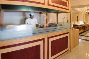 Koch im Eliros Mare Hotel Restaurant brät mit Feuer
