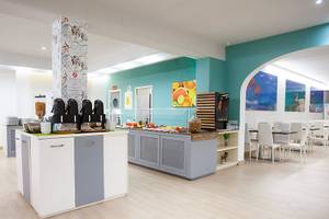 Speisebereich des Rosales Formentera Hotels mit Buffet, Tischen und Stühlen.